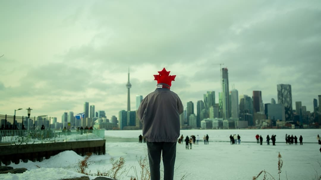 privacy rights. Man with canadian flag hat overlooks toronto skyline