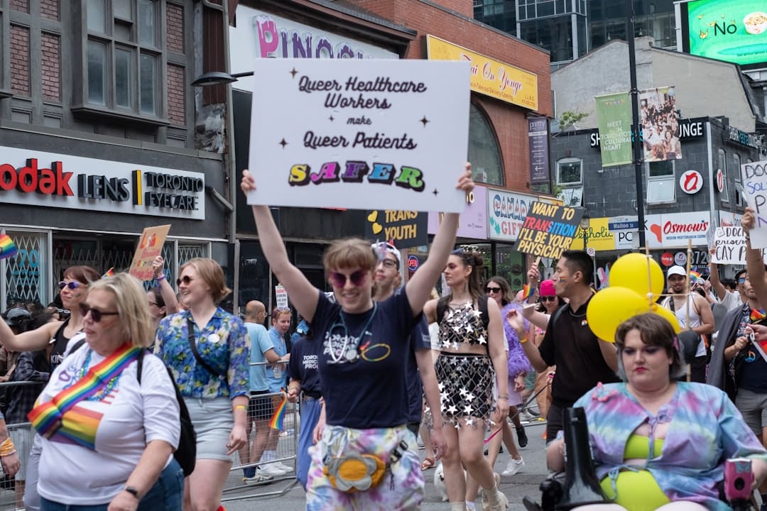 condo support animal — A group of people walking down a street holding signs