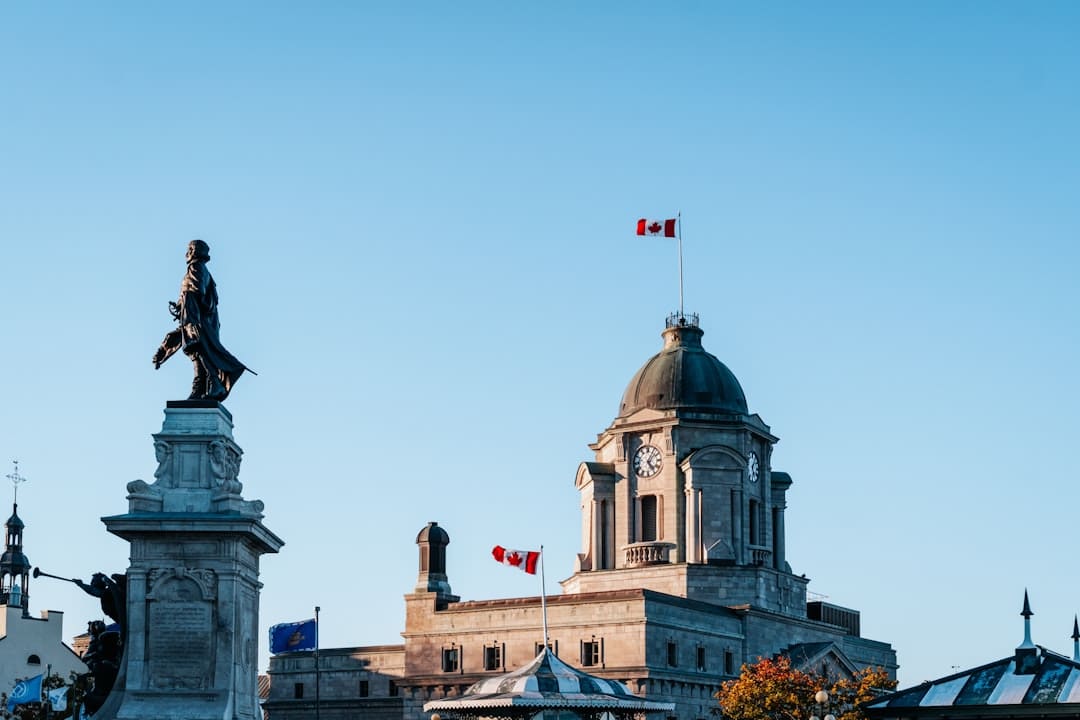 alberta support animal housing — Historic building with statue and canadian flags