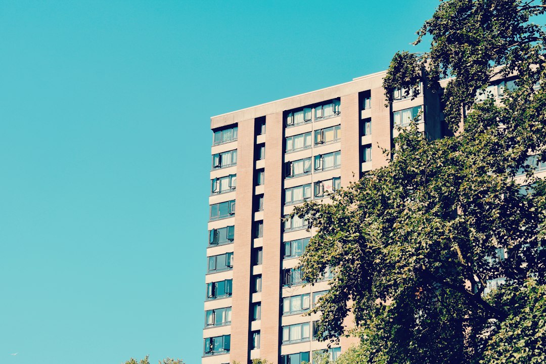 landlord documentation requests — A tall building with lots of windows next to trees